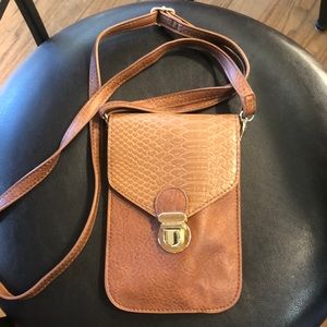 Woman’s cross strap pocketbook that holds your iPhone.